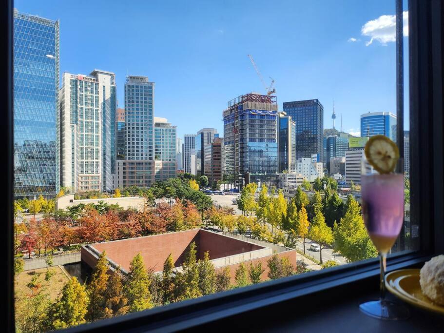 a window with a view of a city skyline at LC Loft City House in Seoul