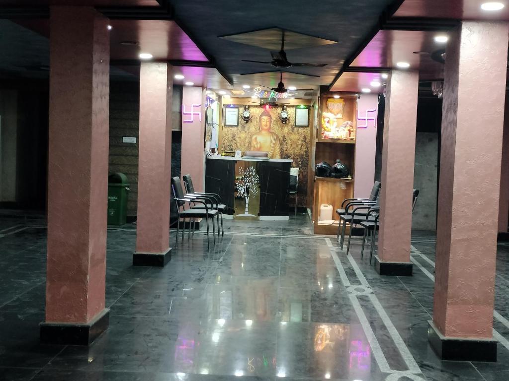 a lobby with chairs and a bar with purple lights at Hotel sweta villa & banquet hall in Bankipur