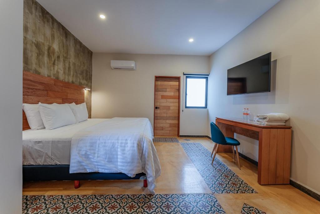 Postel nebo postele na pokoji v ubytování Hotel Casa 57