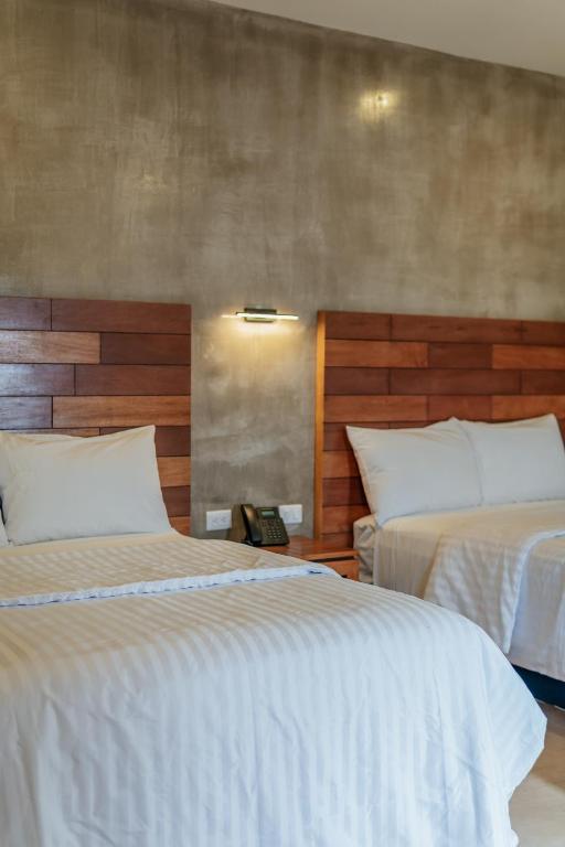 Postel nebo postele na pokoji v ubytování Hotel Casa 57