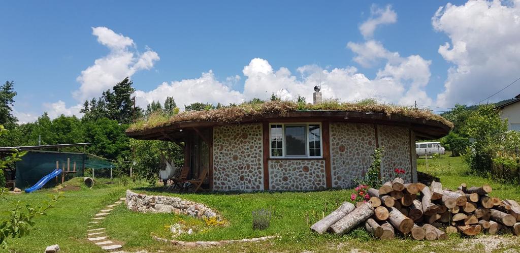 a small house with a grass roof at Wild Cherry Cordwood / Дивите череши in Godech