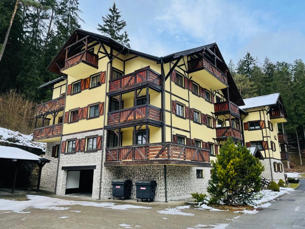 a large apartment building with wooden balconies on it at Apartmán Hrabovo L in Ružomberok