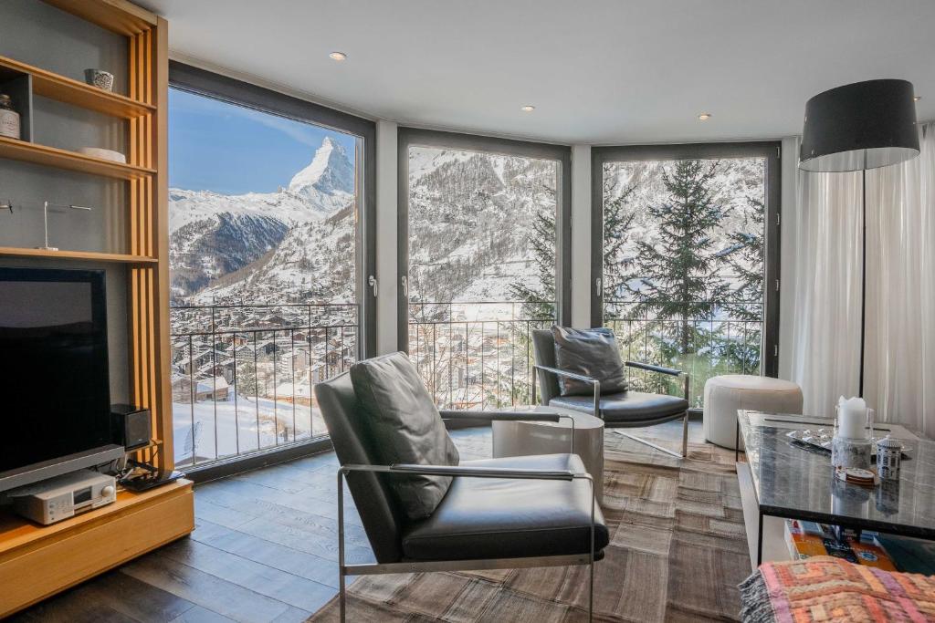 a living room with a view of a mountain at Mountain View Apartment in Zermatt - Denali in Zermatt