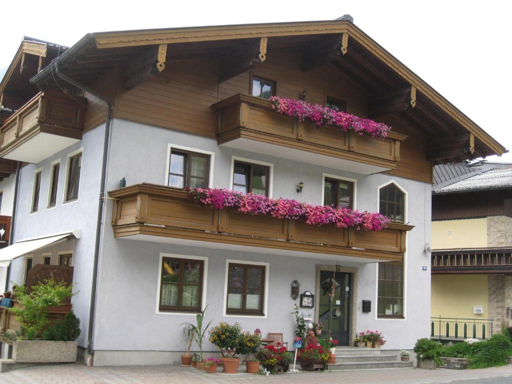 a building with flowers on the balconies of it at Ferienwohnungen Gwehenberger in Kleinarl