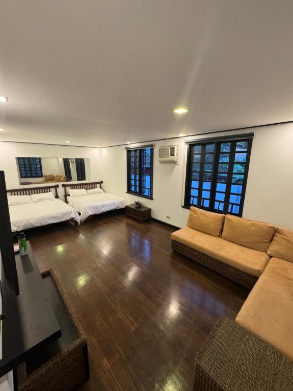 a large living room with two beds and a couch at Colione Bed and Breakfast in Baguio