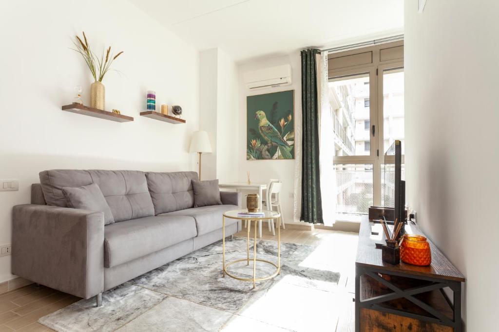 a living room with a couch and a table at The Tropical Place in Milan