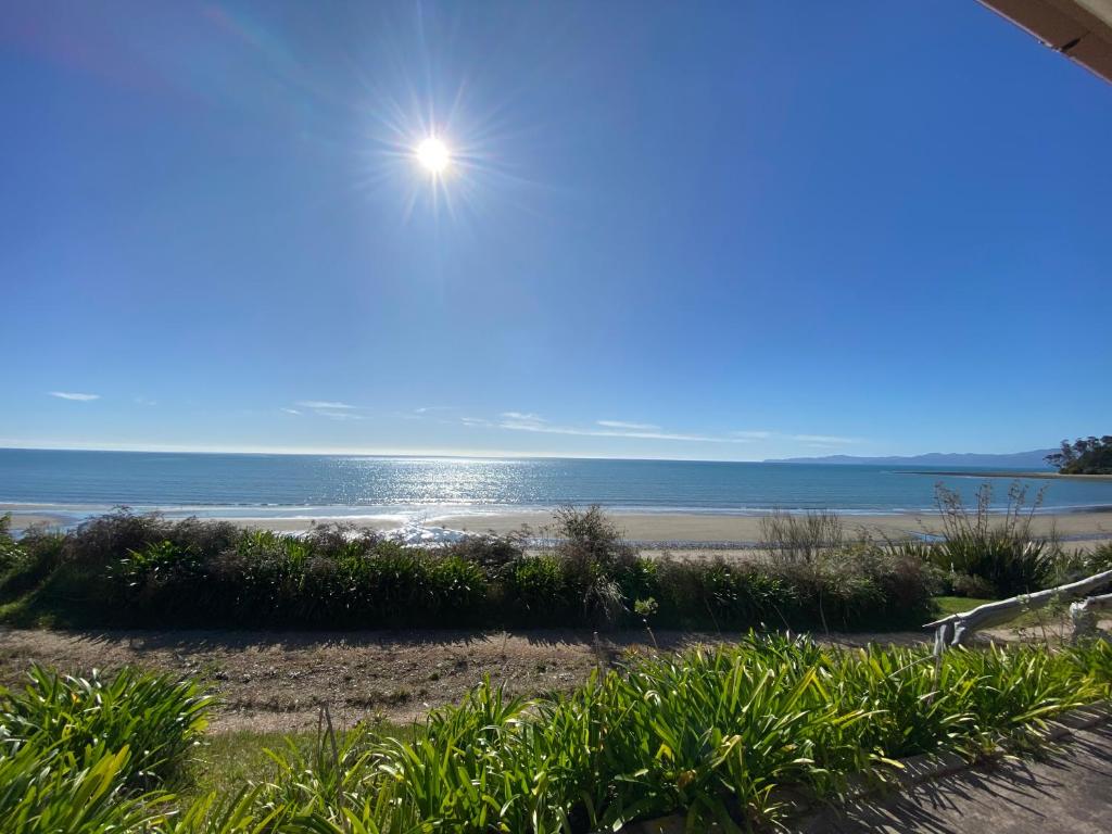 a view of the ocean from a beach at By the Seashaw - Hosted by Lorna, Michael & Katja in Parapara 