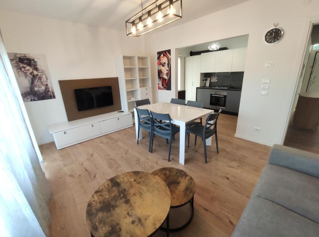 a kitchen and living room with a table and chairs at Casa dei Demi in Pieve di Soligo