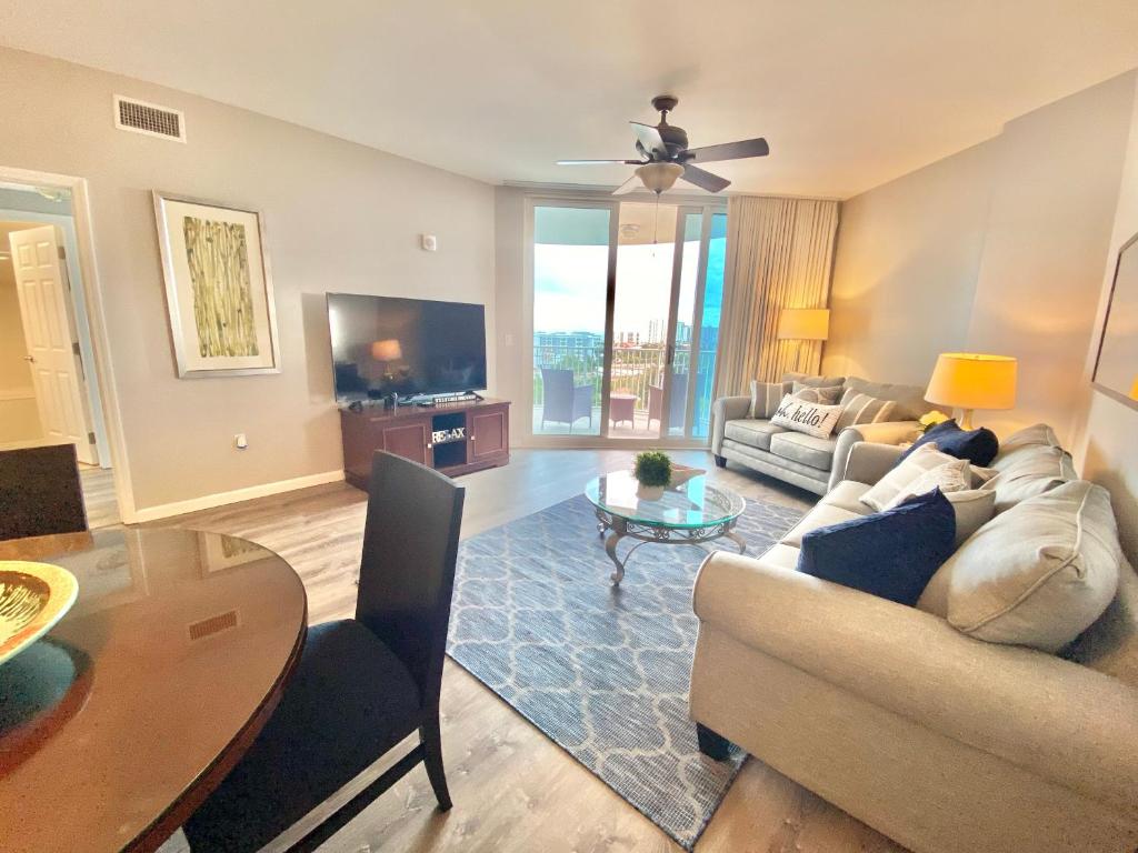 a living room with a couch and a table at Coastal Oasis Retreat at The Palms of Destin! in Destin