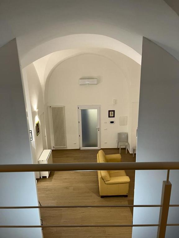 a view of a living room with a yellow couch at Dimora Dilù in Noci
