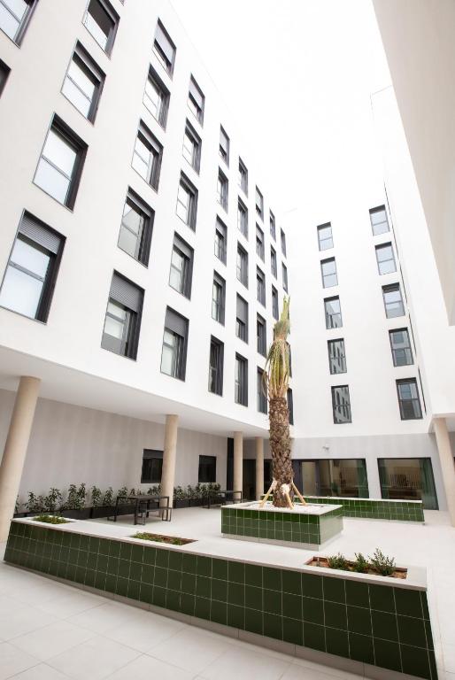 a building with a statue in front of it at Micampus Burjassot Parque Student Residence in Burjassot