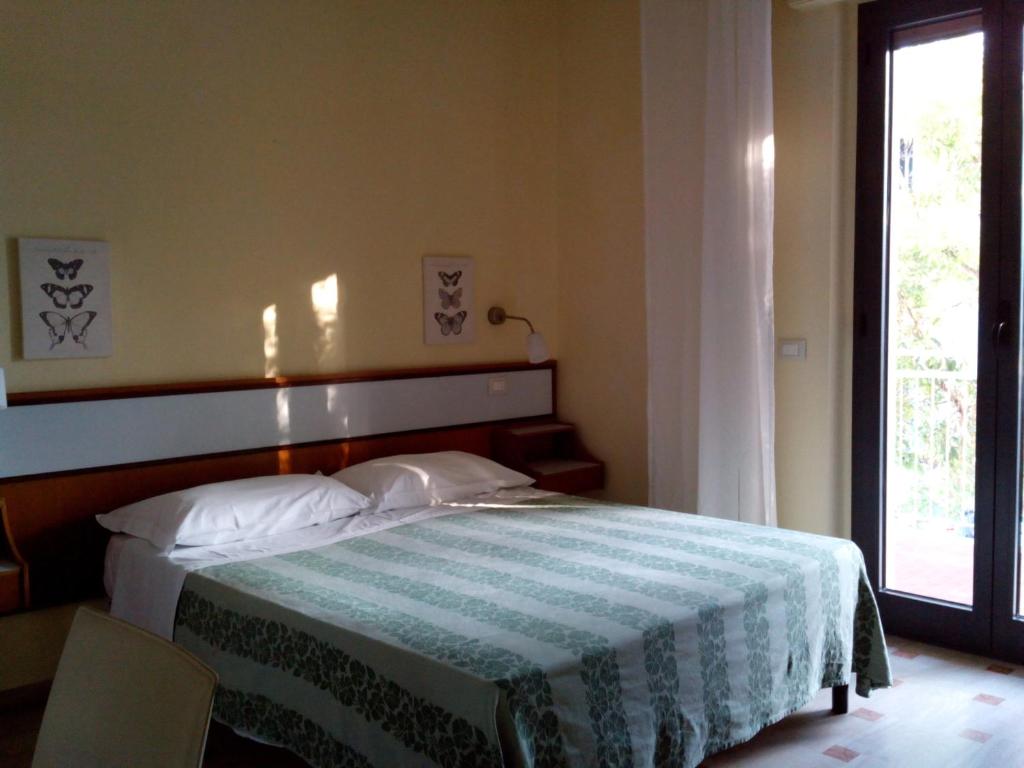 Postel nebo postele na pokoji v ubytování Hotel Sette Note
