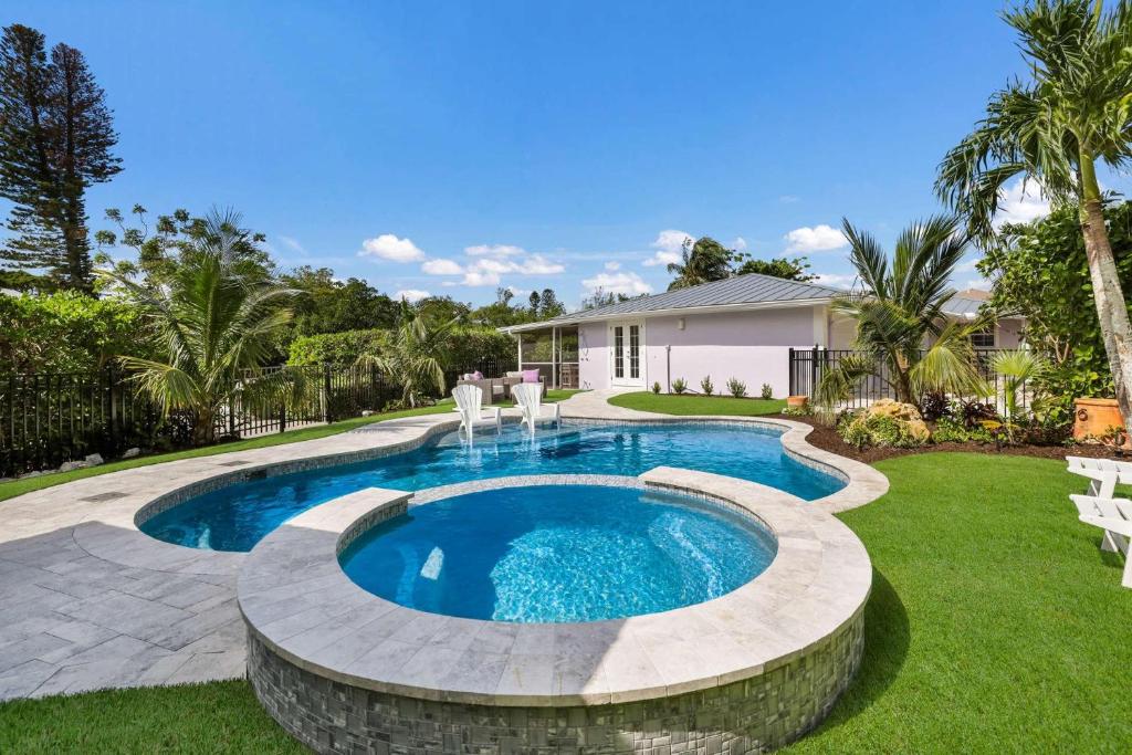 a swimming pool in a yard next to a house at Lavender Lagoon in Anna Maria