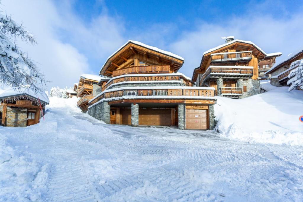 a log cabin in the snow in front at Chalet Lyskamm in Montvalezan