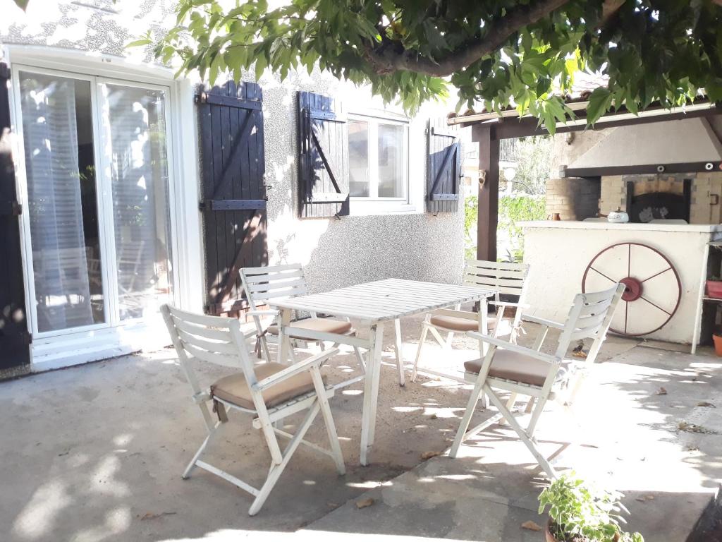 a white table and chairs on a patio at GITE EN PROVENCE in Istres