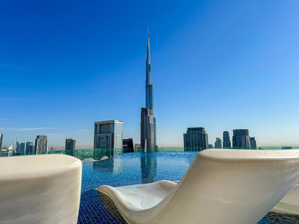 a pool with a view of the burj khalifa at FULL Burj Khalifa view LUX 2Bedroom with Rooftop Pool Central location in Paramount Hotel Midtown in Dubai