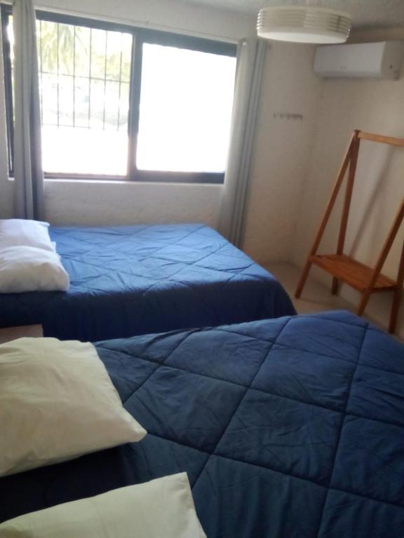 Postel nebo postele na pokoji v ubytování Naranjo Hostel