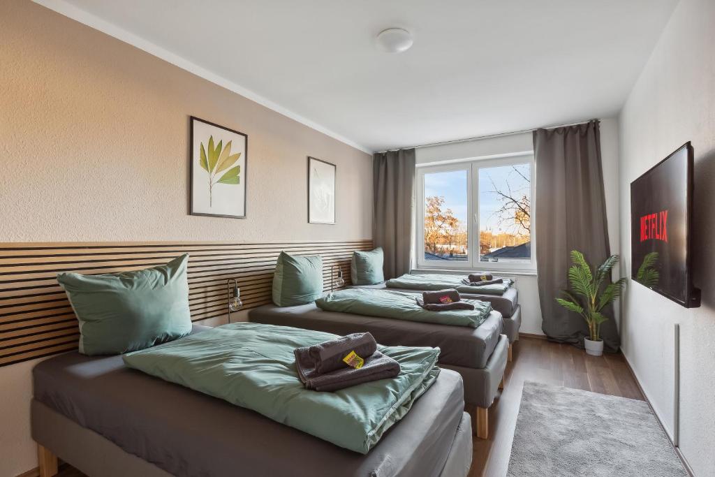 Habitación de hotel con 2 camas y ventana en *NulandtApartment* #2 en Merseburg