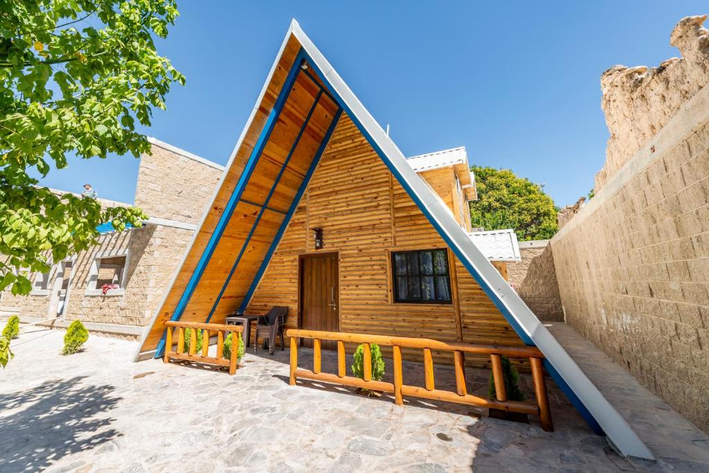 a house shaped like a giant mirror with a porch at ÑAÑO V in San Antonio de las Alzanas