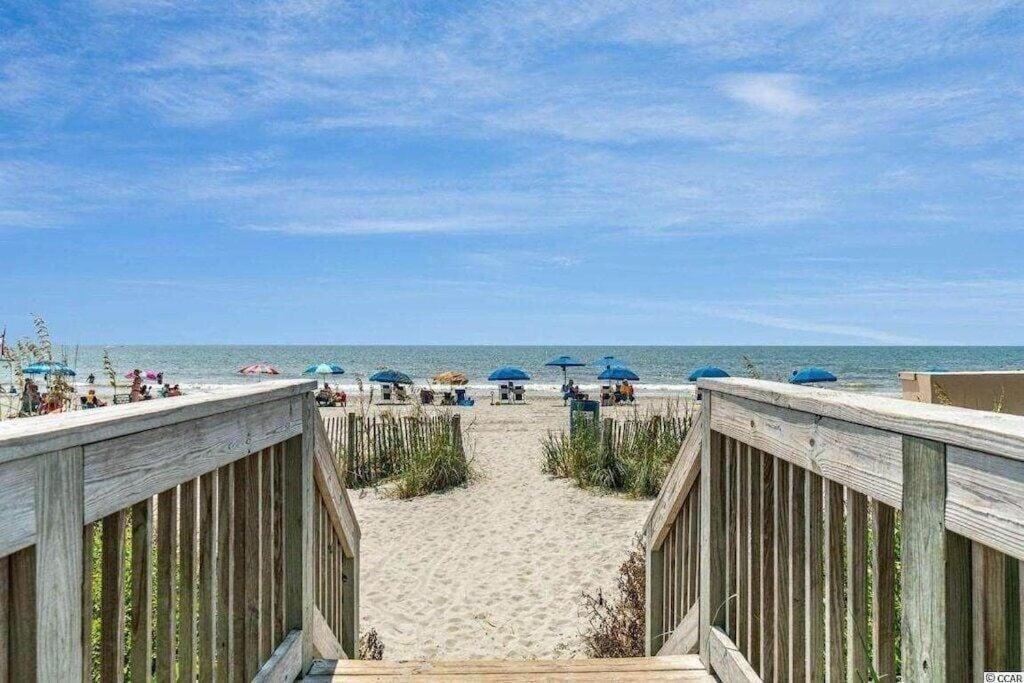 a view of a beach with umbrellas and the ocean at 2501 S Ocean Blvd, 1017 - Ocean View Sleeps 6 in Myrtle Beach