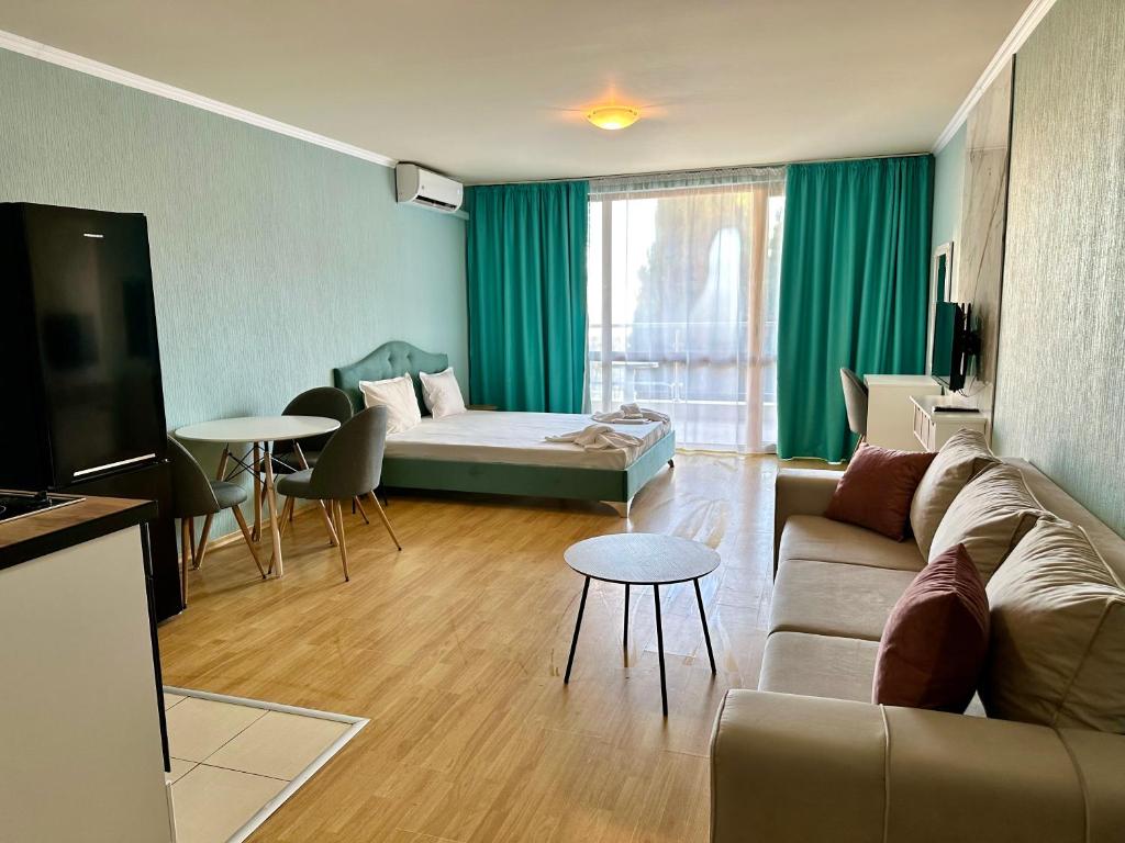 a living room with a couch and a table at Apartments in Panorama Beach Vigo Nessebar in Nesebar