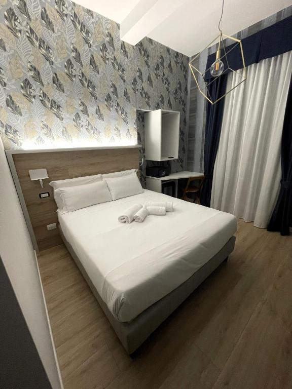 Postel nebo postele na pokoji v ubytování ROME'S GLORIA HOTEL