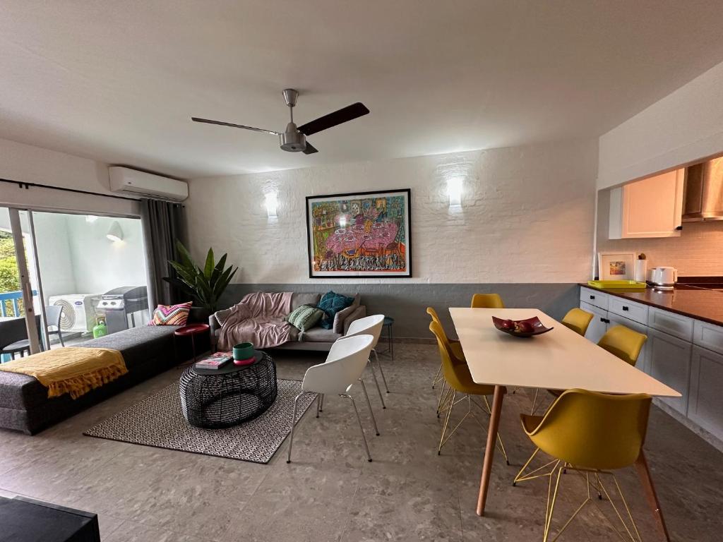 a living room with a couch and a table and chairs at Santorini - Kallisti 25, Ballito Family only in Ballito