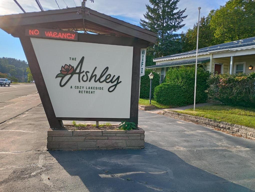a sign in front of a building in a street at The Ashley in Saranac Lake
