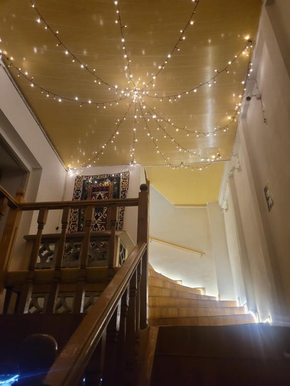 a room with a ceiling with lights and stairs at Friends Hostel in Tbilisi City