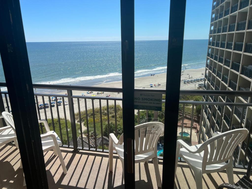 a view of the beach from the balcony of a condo at 4800 S Ocean Blvd, 0915 - Ocean Front Sleeps 6 in Myrtle Beach
