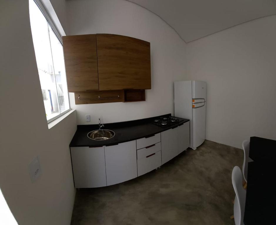 a small kitchen with a sink and a refrigerator at Jefferson Florentino de Araujo in Hortolândia
