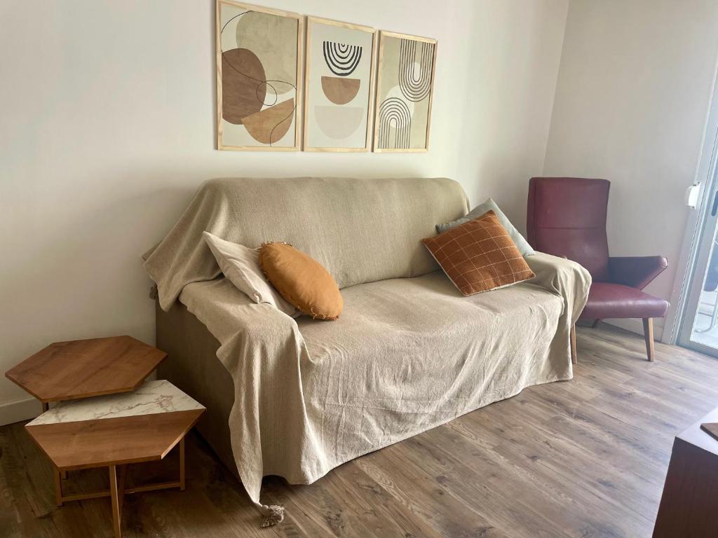 a couch with pillows on it in a living room at Nuevo y confortable apto con parrilla in Montevideo