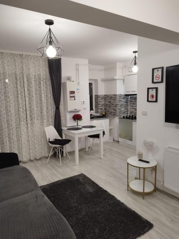 a living room with a couch and a table at Dream Arena Apartment in Bacău