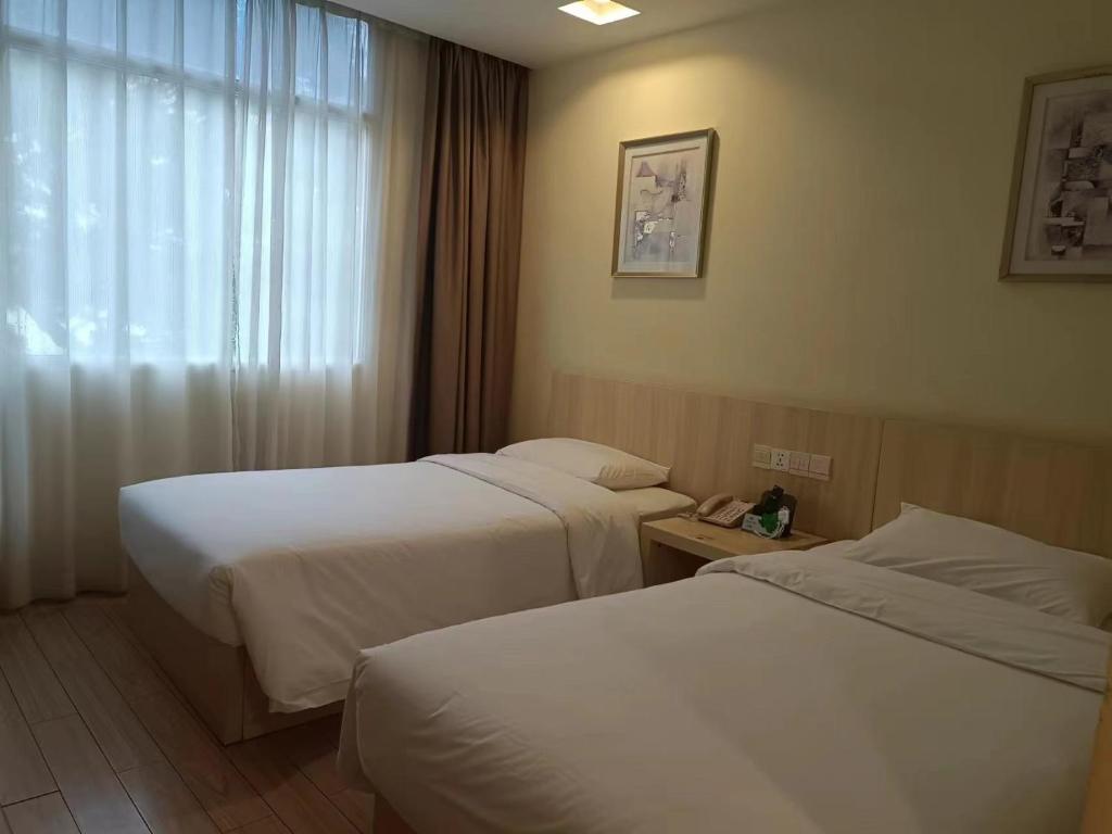 Postel nebo postele na pokoji v ubytování Guangdong Baiyun City Hotel