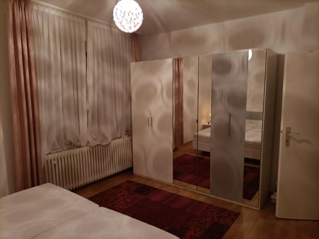 a bedroom with a bed and a large mirror at Double room in Bielefeld