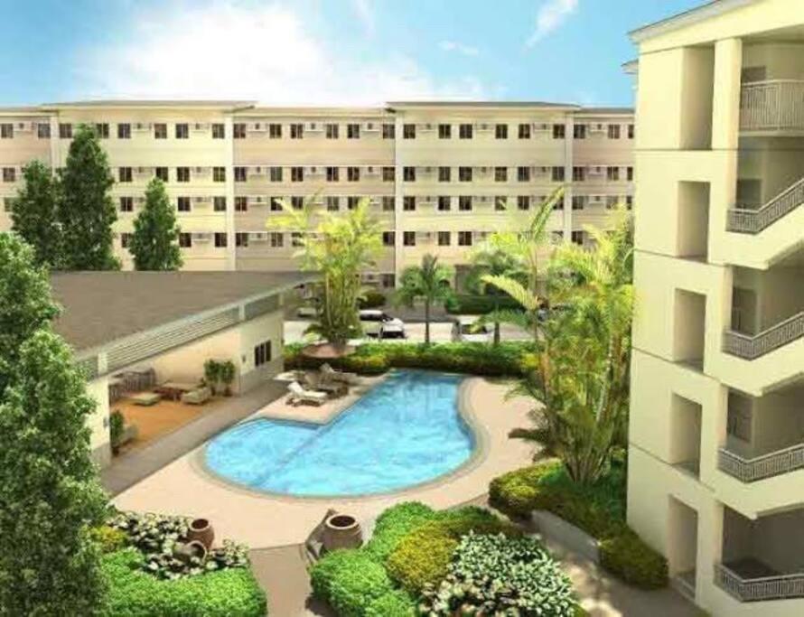 an overhead view of a building with a swimming pool at Staycation at SMDC Cheers Residences Marilao in Marilao