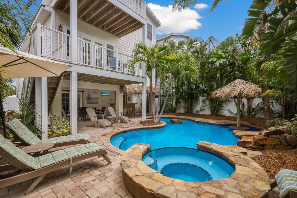 a swimming pool in the backyard of a house at Margarita-Ville in Holmes Beach