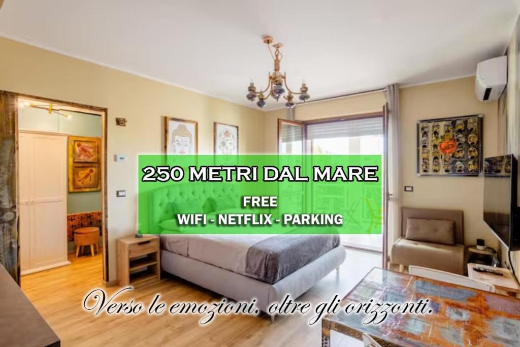a living room with a bed and a chandelier at [3' a piedi dal mare] CASITA DEL MAR...Mare & Arte in Grottammare