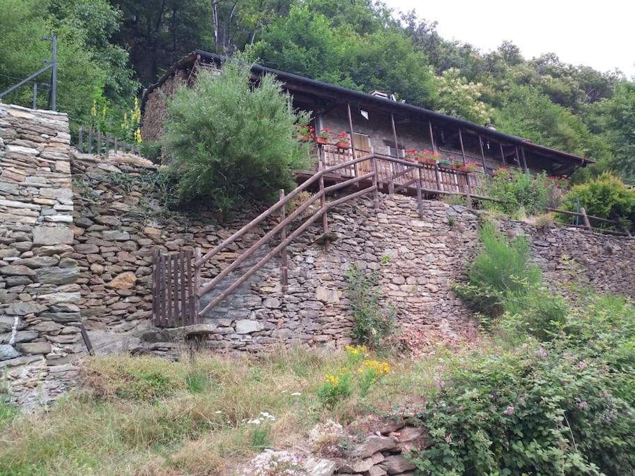 a stone wall with a building on top of it at Shangri-La in Villar Pellice