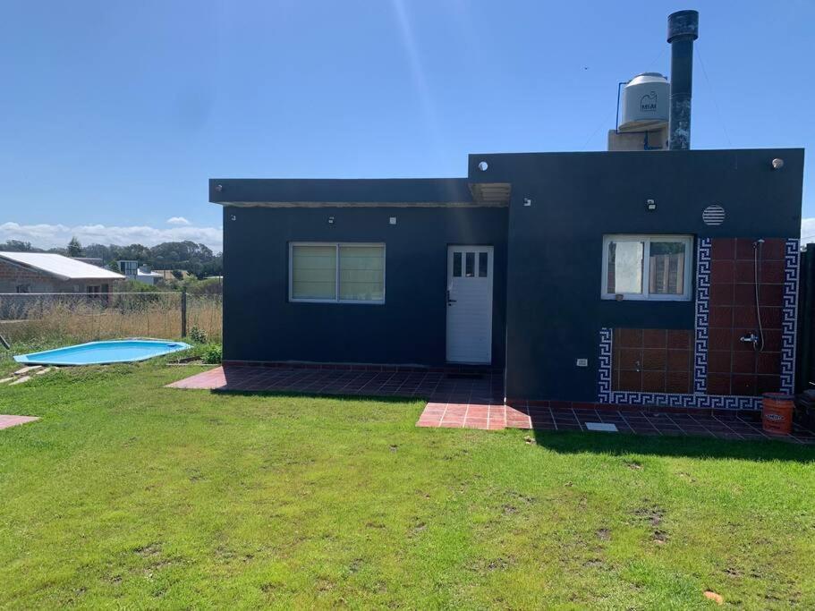 a small blue house with a yard with a yard at 4 personas en paz in Mar del Plata