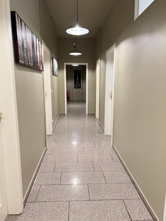 korytarzem z podłogą wyłożoną kafelkami w budynku w obiekcie Arsi Hostel w mieście Hamburg