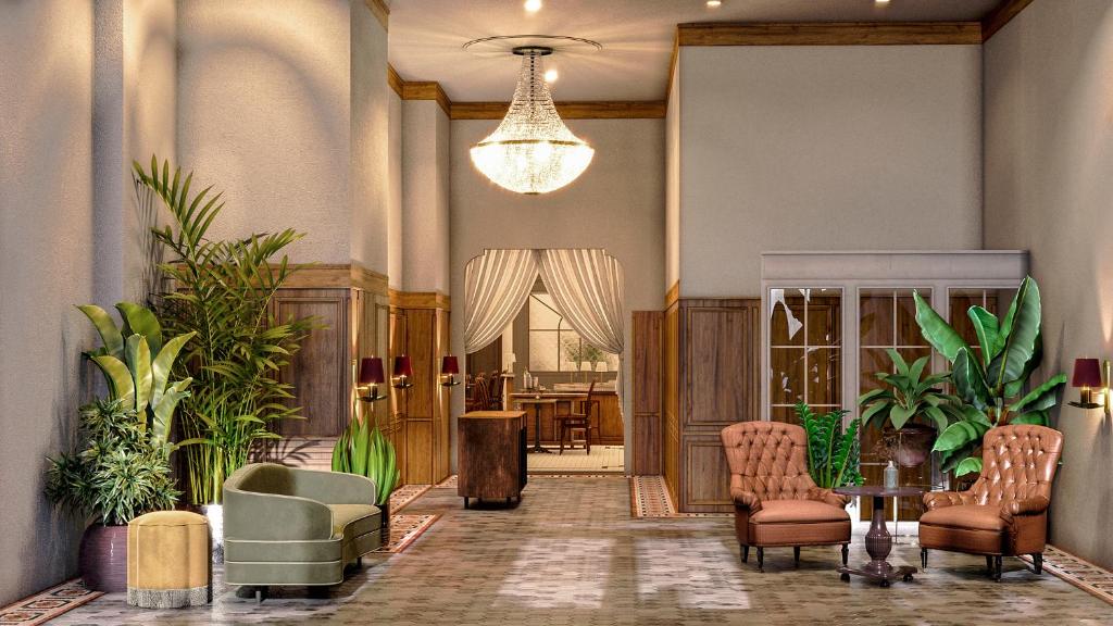 a lobby with chairs and tables and a chandelier at Hotel Cleo Knoxville in Knoxville