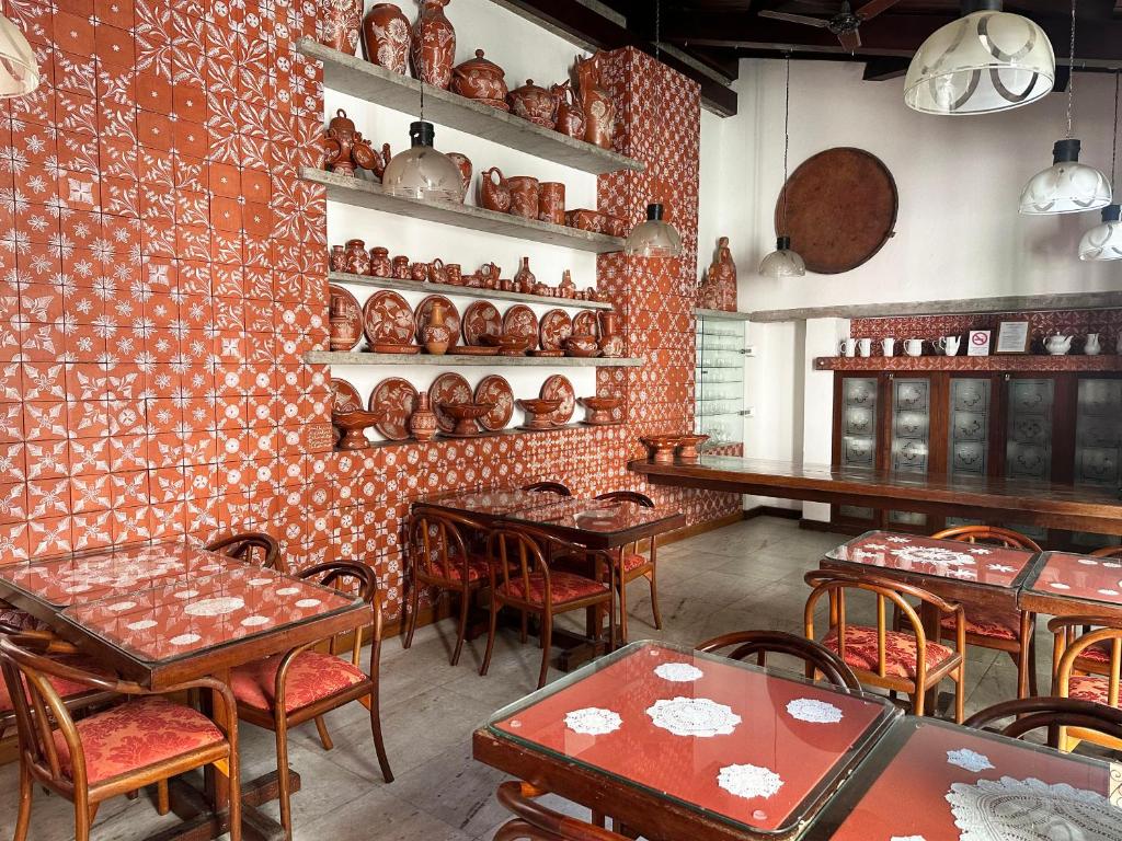 a restaurant with tables and chairs in a room at Hotel Catharina Paraguaçu in Salvador