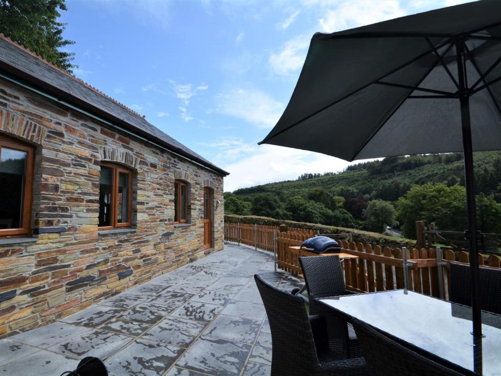 a patio with a table and an umbrella at 3 bed in Fowey 53664 in Warleggan