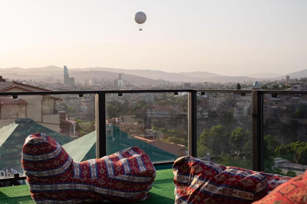 a room with a view of a city at Brooch Boutique Hotel in Tbilisi City