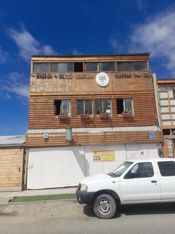 a white car parked in front of a building at hostal consulado in Caldera