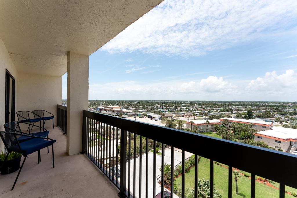 a balcony with a view of a city at Beach views with top complex amenities and covered parking! in Ormond Beach