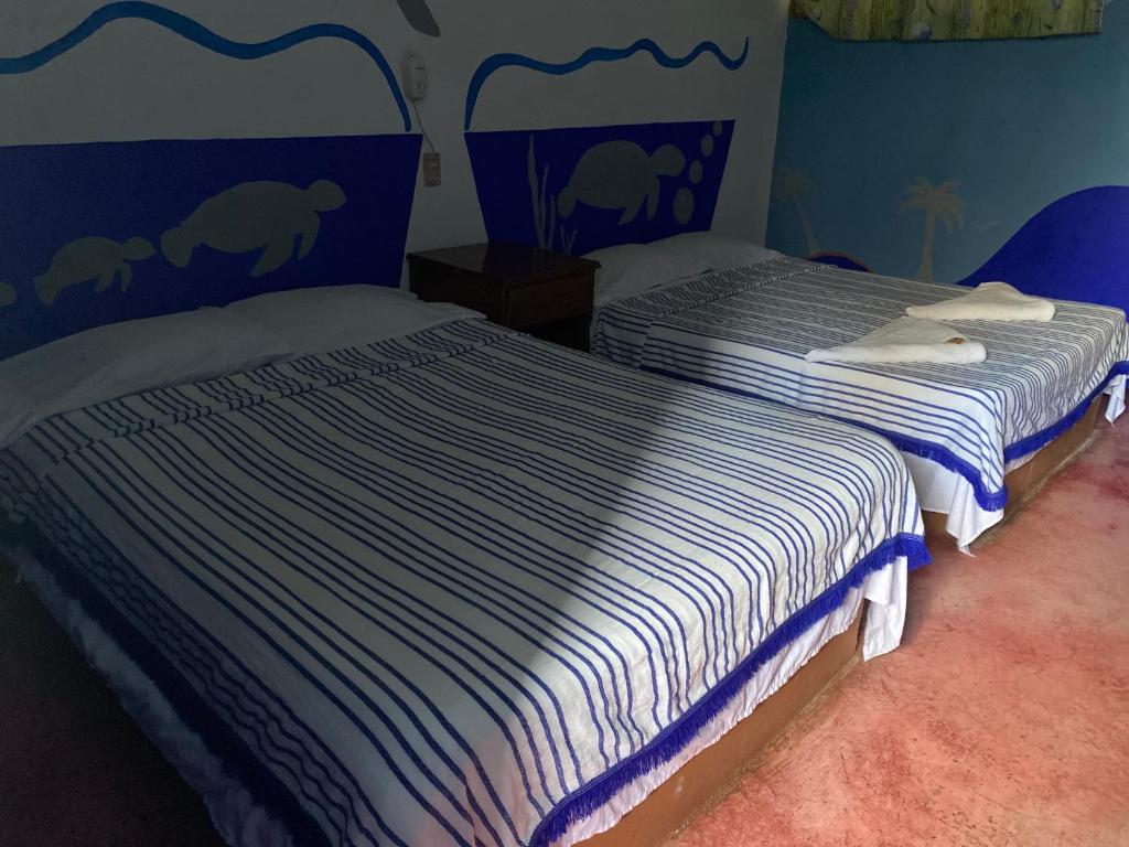 Postel nebo postele na pokoji v ubytování Hotel Lu'um