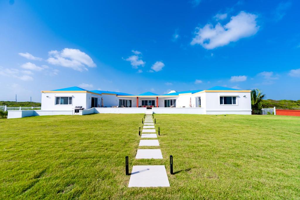 a pathway in the middle of a large grass field at Lovely 4-Bed Villa in Anguilla in Long Path