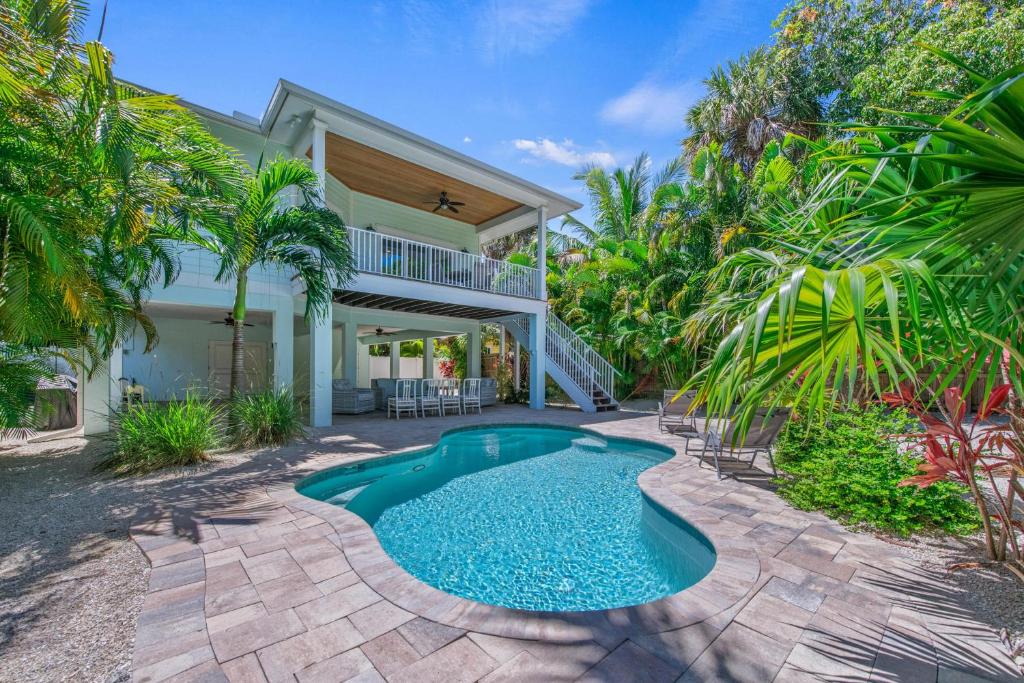 a swimming pool in the backyard of a house at Spring Haven in Anna Maria